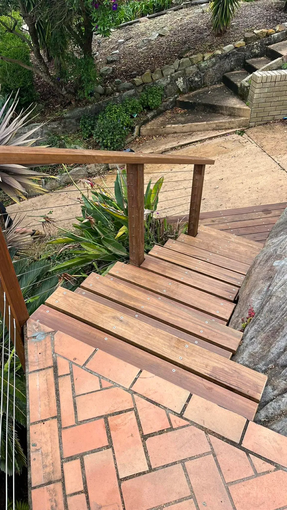 Hardwood garden steps with stainless wire balustrade in landscaped backyard