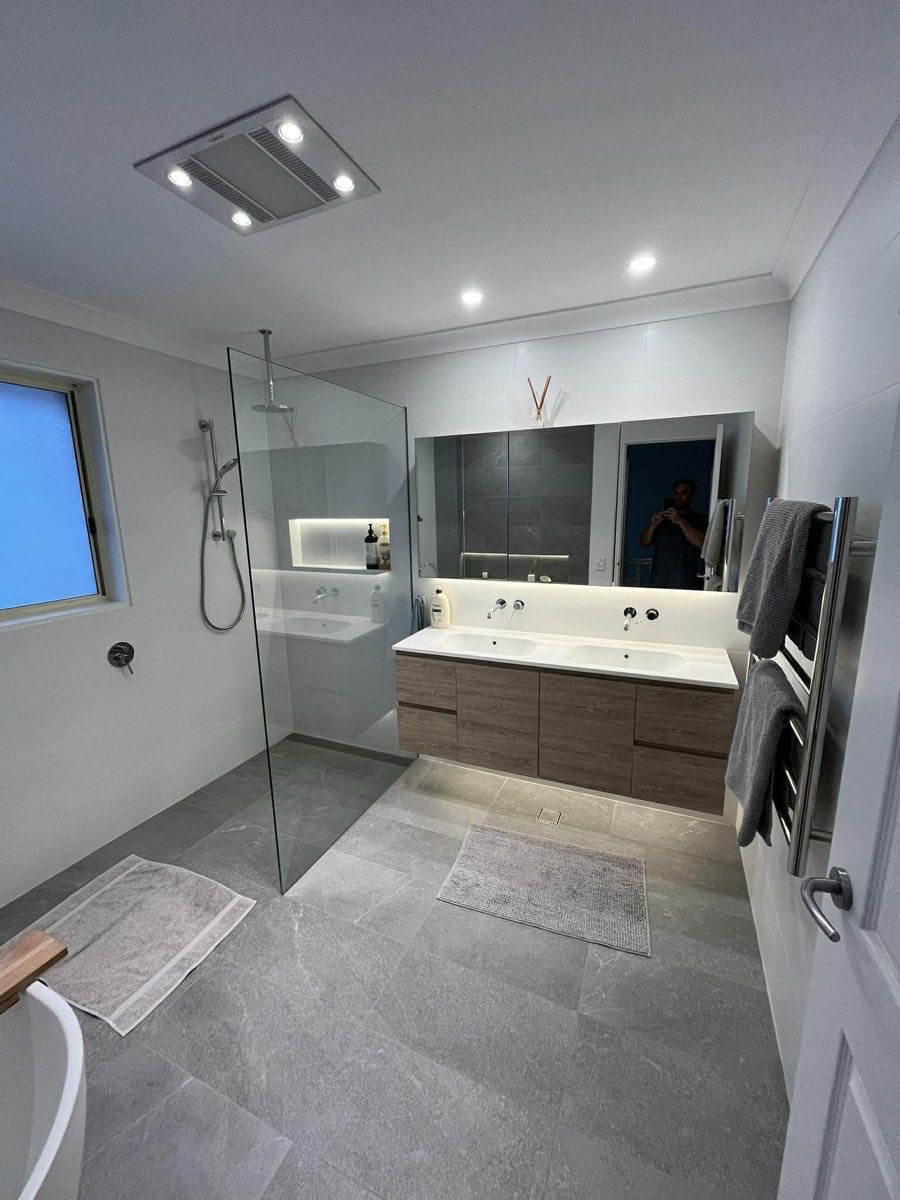 Modern bathroom with double vanity and glass shower
