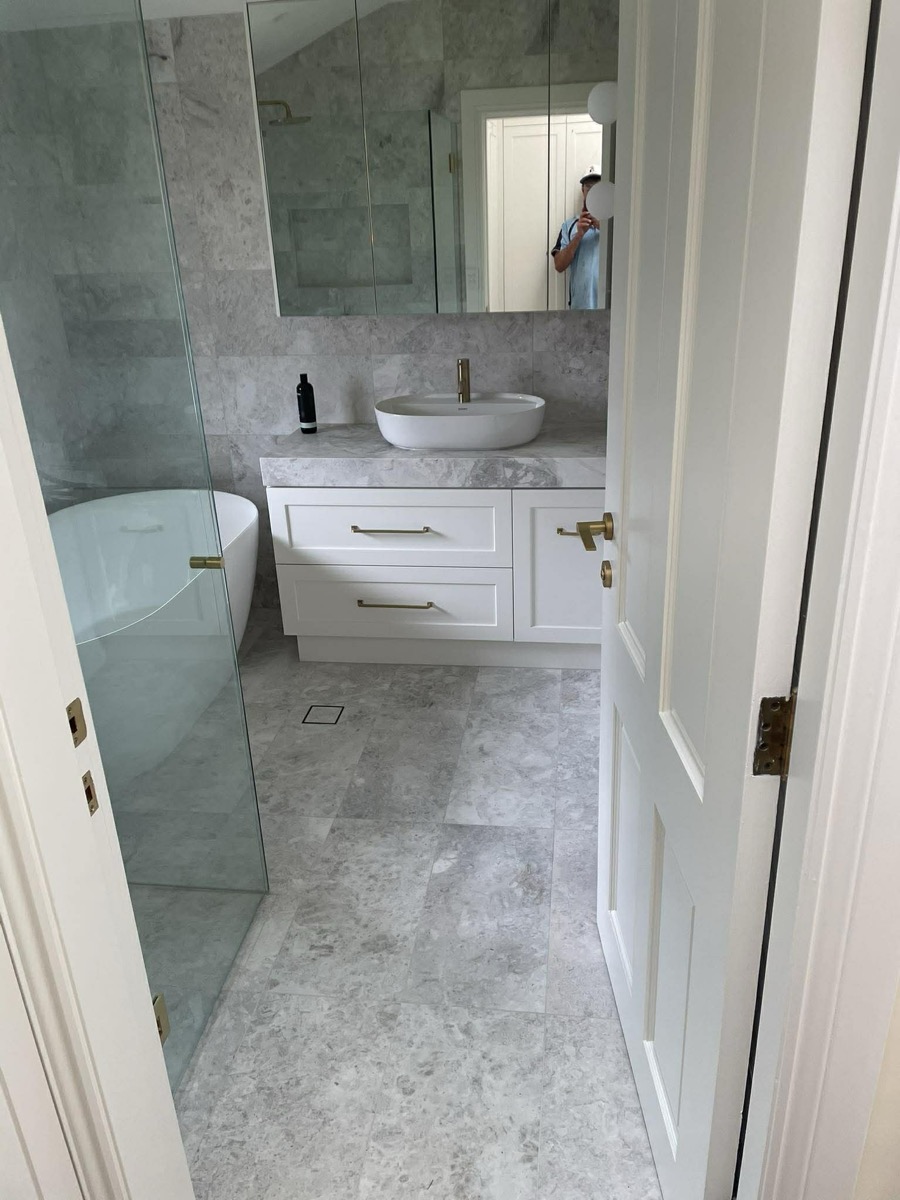 Marble bathroom renovation with freestanding tub and gold hardware, Northern Beaches