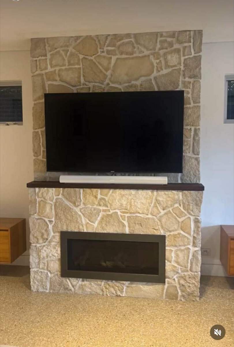 Stone fireplace surround with TV mount