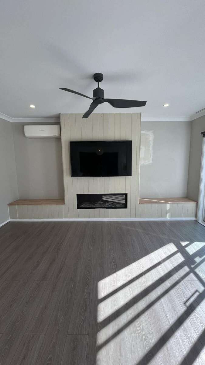 Custom fireplace wall with VJ panelling and timber shelves