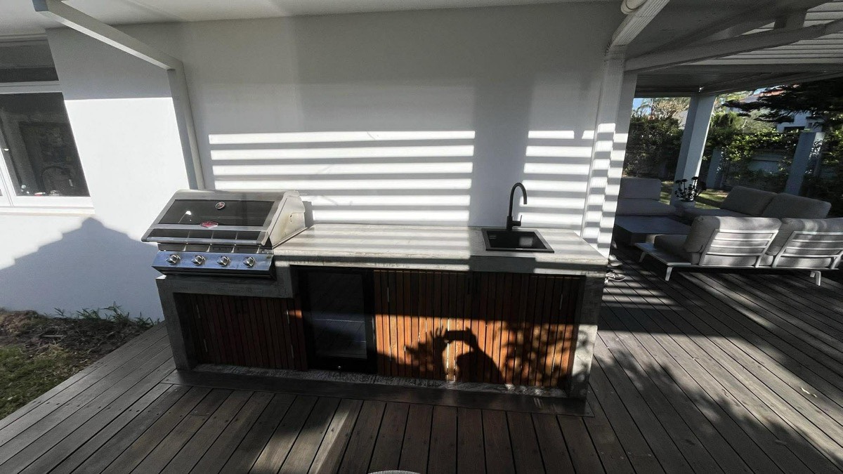 Outdoor kitchen with BBQ and timber slat cladding